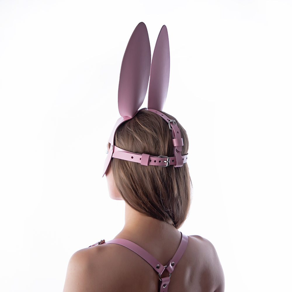 Girl wearing pink bunny mask